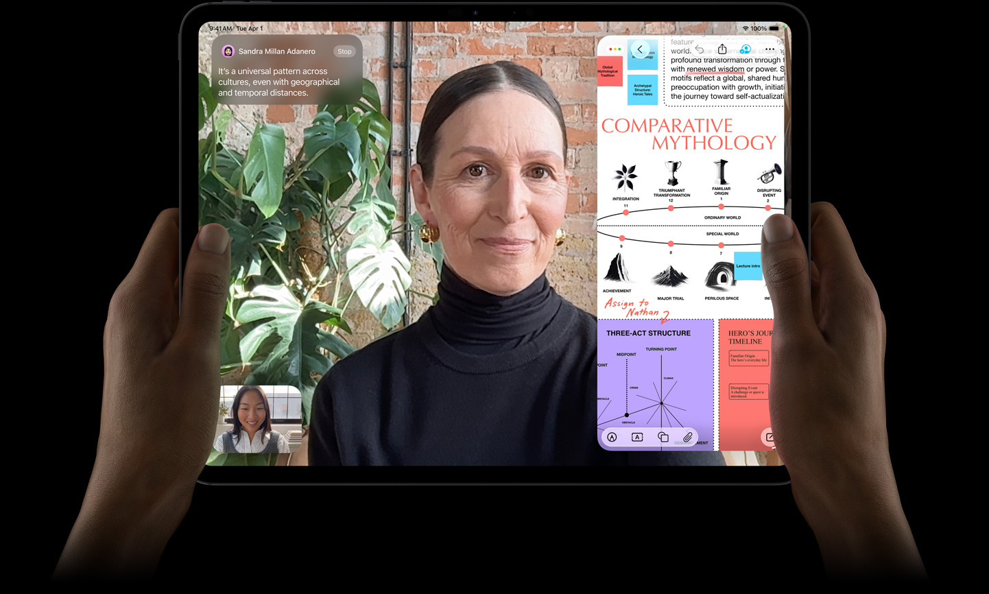 iPad Pro, önden dış görünüm, uzay siyahı rengi, aygıt yatay pozisyonda sol ve sağ ellerle tutuluyor, yuvarlatılmış köşeler, siyah ekran çerçevesi, ekranda canlı çevrilen bir FaceTime görüşmesi ile metin, şema ve el yazısı notların yer aldığı “Karşılaştırmalı Mitoloji” sunumunu içeren bir eğitim uygulaması gösteriliyor